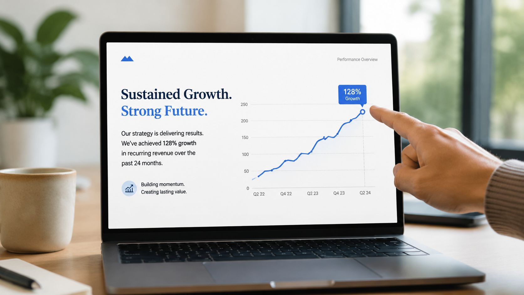 A hand pointing at a laptop screen displaying a business presentation graph showing strong revenue growth.